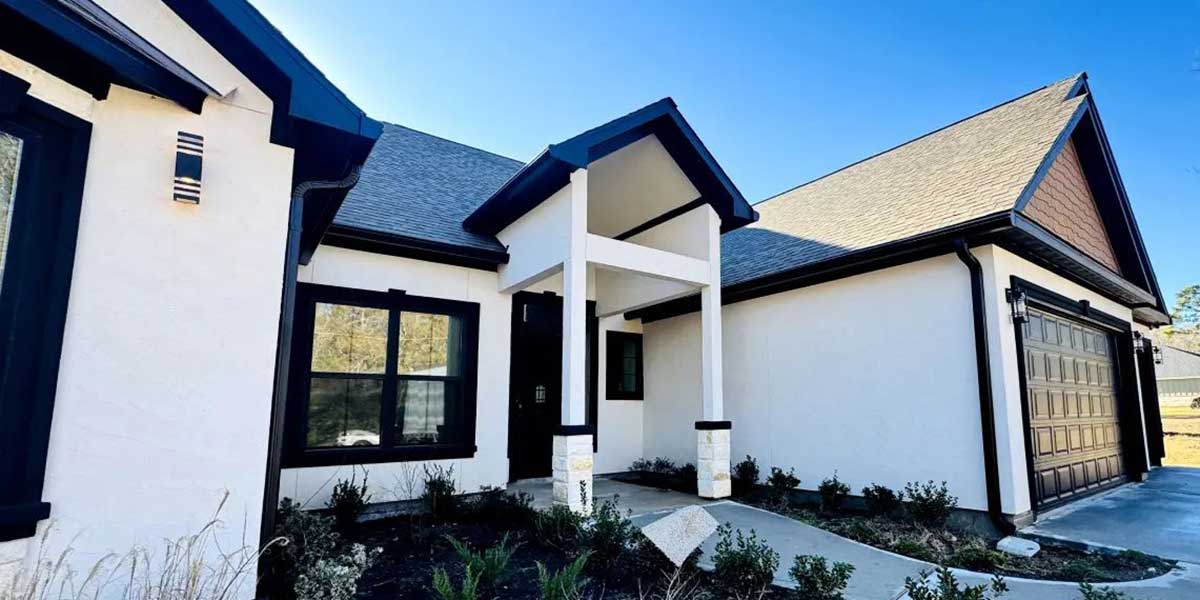 Modern Austin home with durable black metal gutters designed to withstand intense sun, heat, and heavy rainstorms.